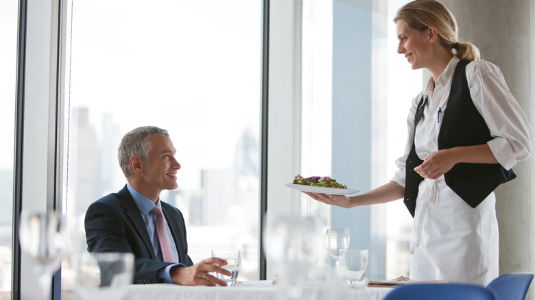 Waitress interacting with restaurant customer