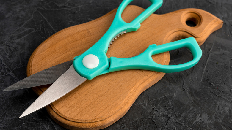 kitchen shears on wooden cutting board