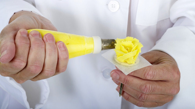 Chef using a flower nail to create flower