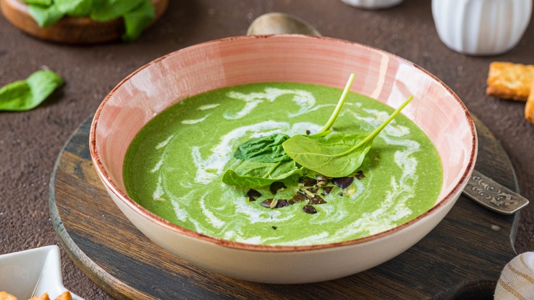 Spinach soup in pink bowl