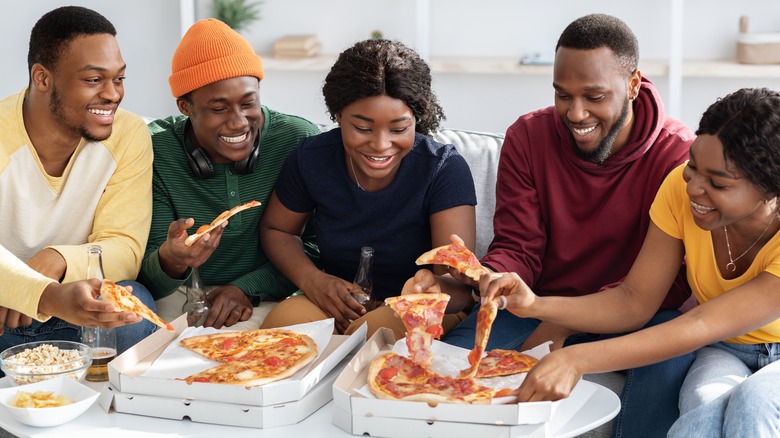 Group of friends eating pizza