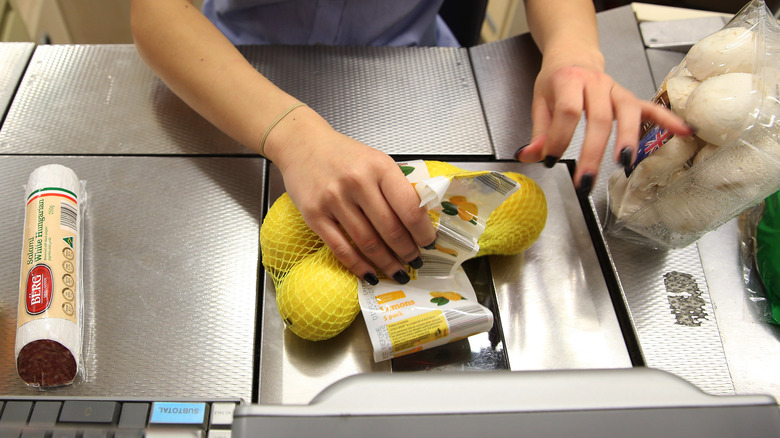 Aldi employee scanning groceries