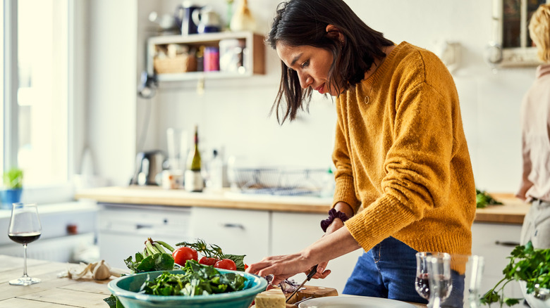 Person preparing a salad