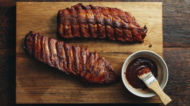 Ribs and barbecue sauce on board