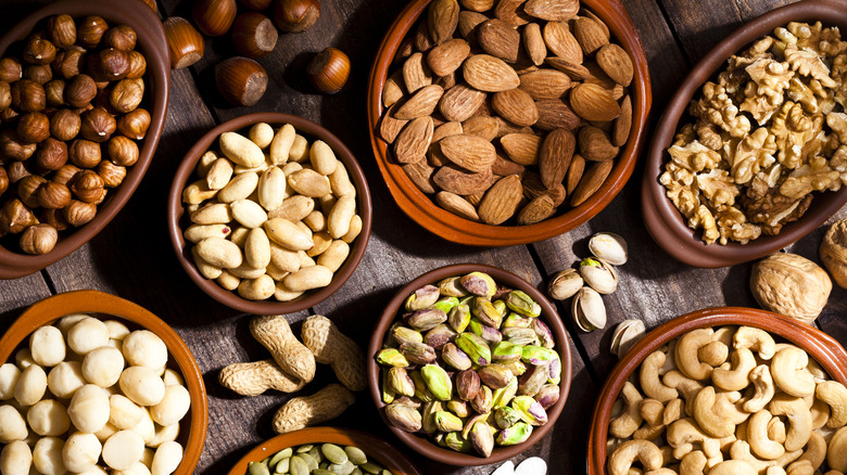 Bowls of different kinds of nuts on a table