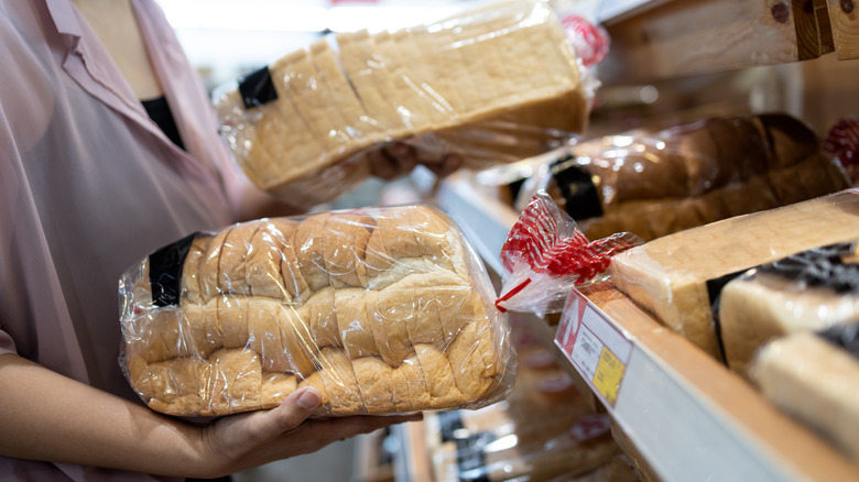 Shopper with two loaves of bread