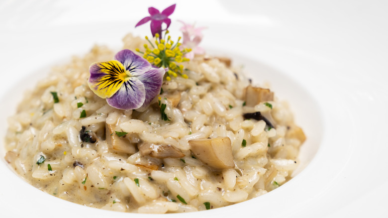 Risotto in a bowl topped with white truffles