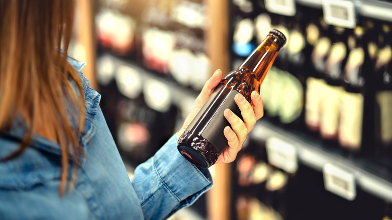 Shopper reading a beer label