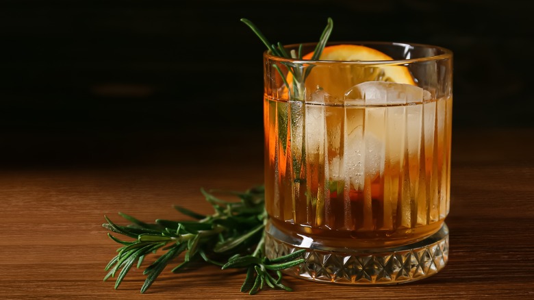 Old Fashioned cocktail with citrus slice and rosemary 