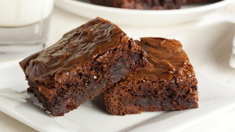two fudgy brownies on a plate