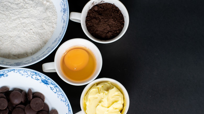Brownie ingredients, including flour, cocoa, eggs, butter and chocolate are seen from above