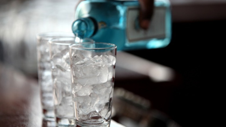 gin poured in a glass with ice