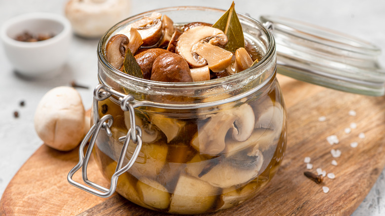 Jar full of sliced brown mushrooms