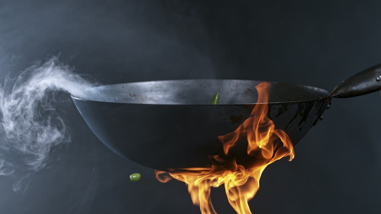 Seasoning wok over fire