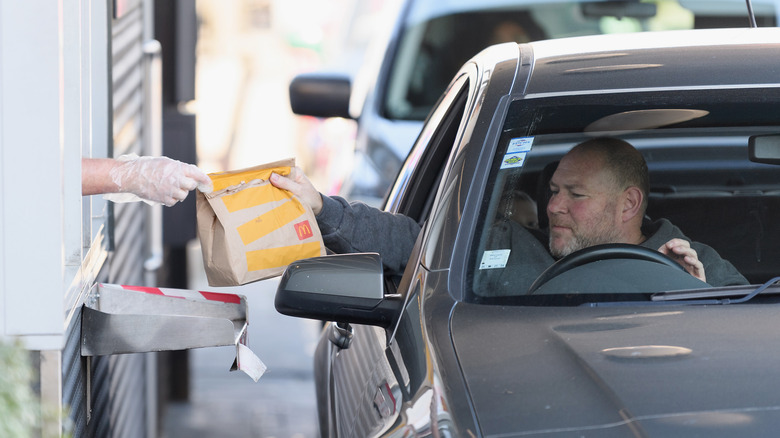 McDonald's customer receiving food at drive-thru