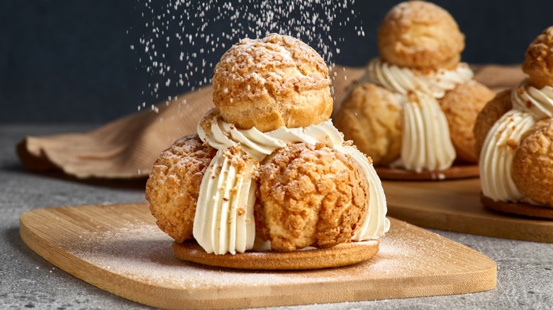 Cream puffs on wood board