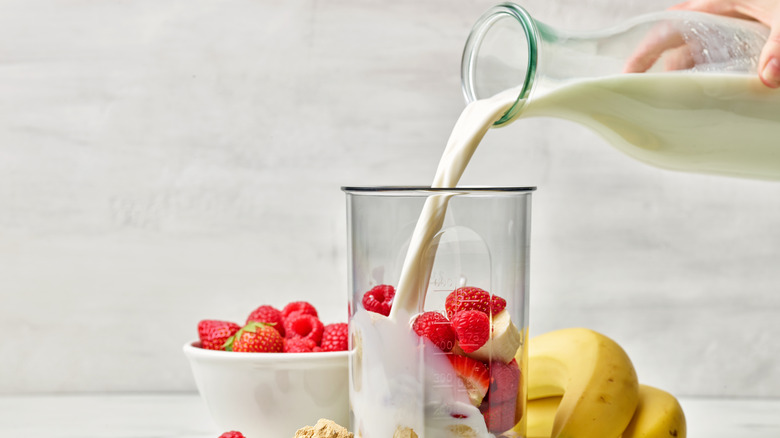 Smoothie in a blender with buttermilk pour