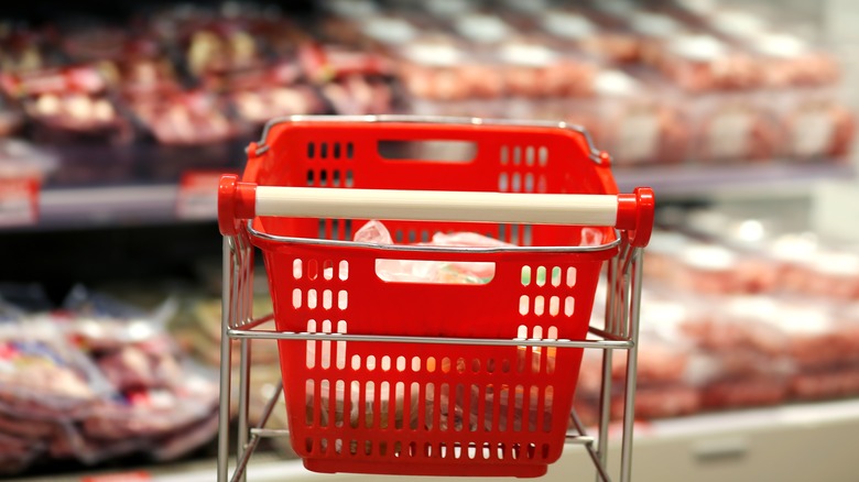 Red cart in front of store-bought meat 