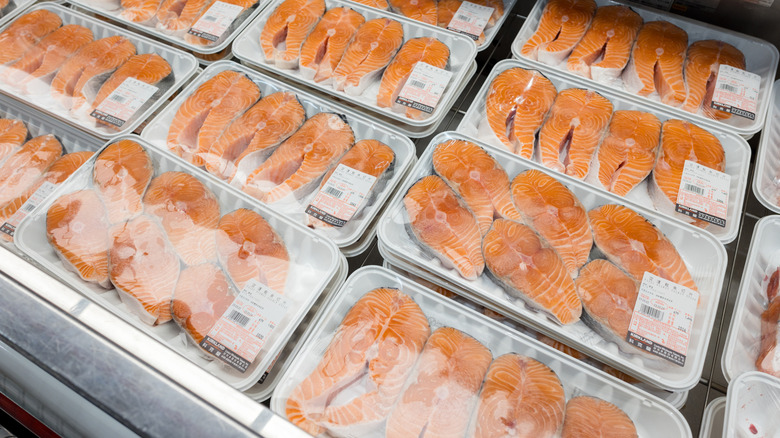 Shelves with fresh salmon in supermarket