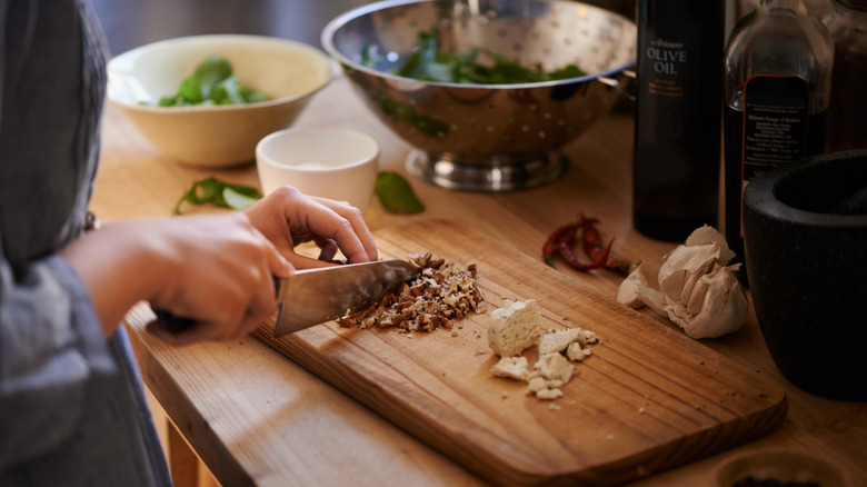 chopping nuts for salad on cutting board