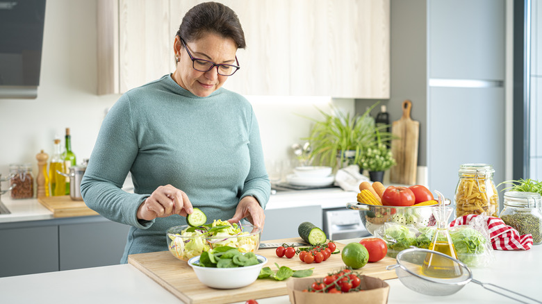 woman making a salad in kitchen