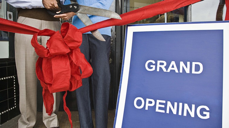 cutting grand opening ribbon