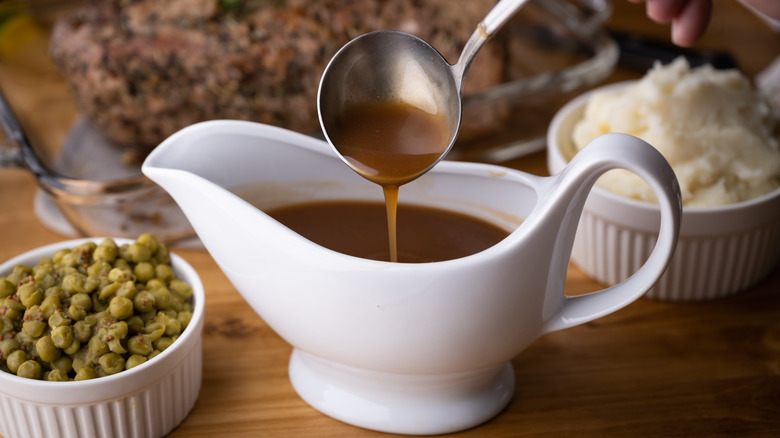 ladle spooning gravy into boat