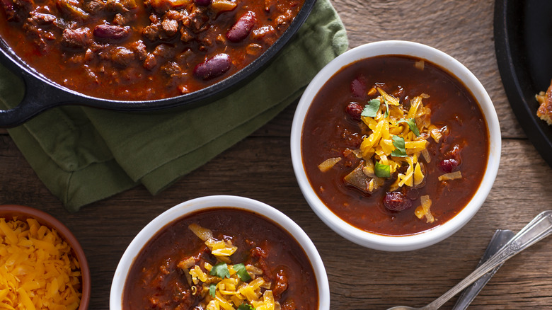 Chili with cheese on it in bowls