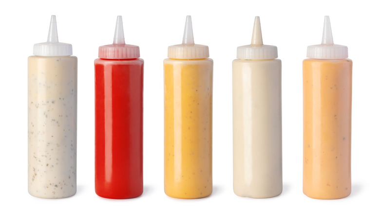 squeeze bottles containing various sauces 