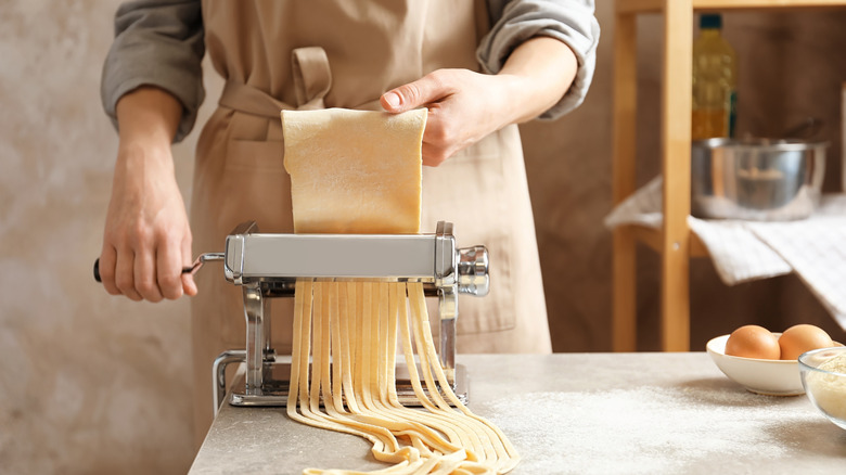 person using pasta maker