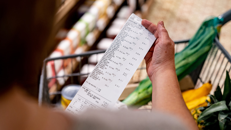 Shopper looking at receipt 