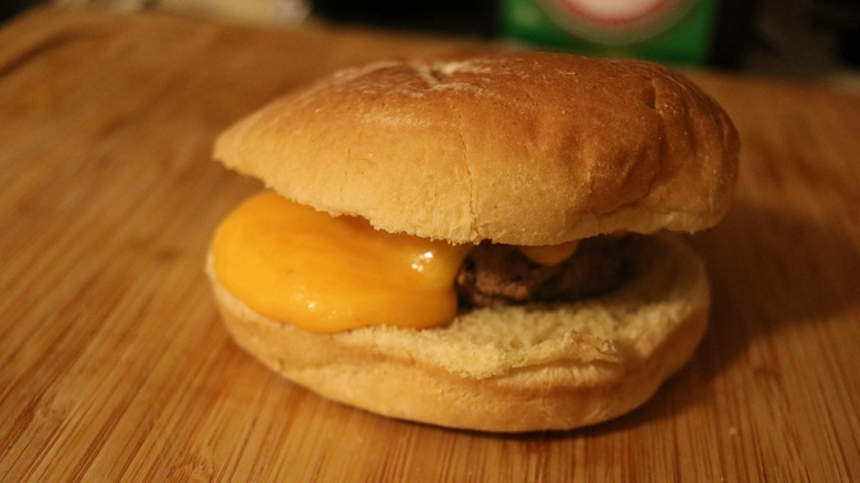 Steamed cheeseburger on wooden surface