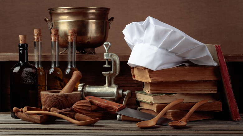 Chef's toque on top of old cookbooks