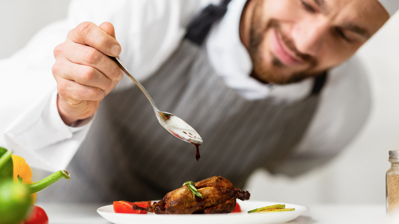 Person plating and saucing food