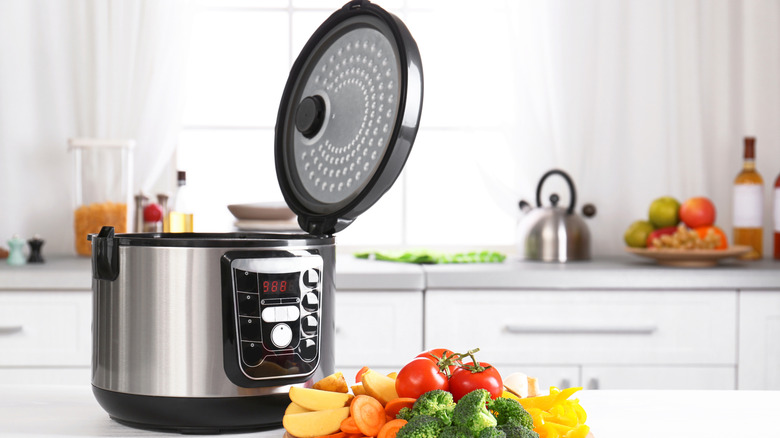 A slow cooker with the lid open on a kitchen counter