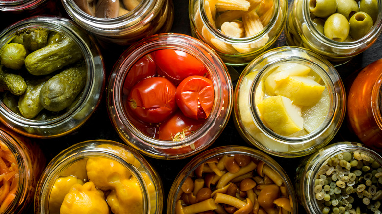 overhead of vegetables in open jars