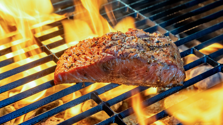 Salmon fillet on the grill with flames