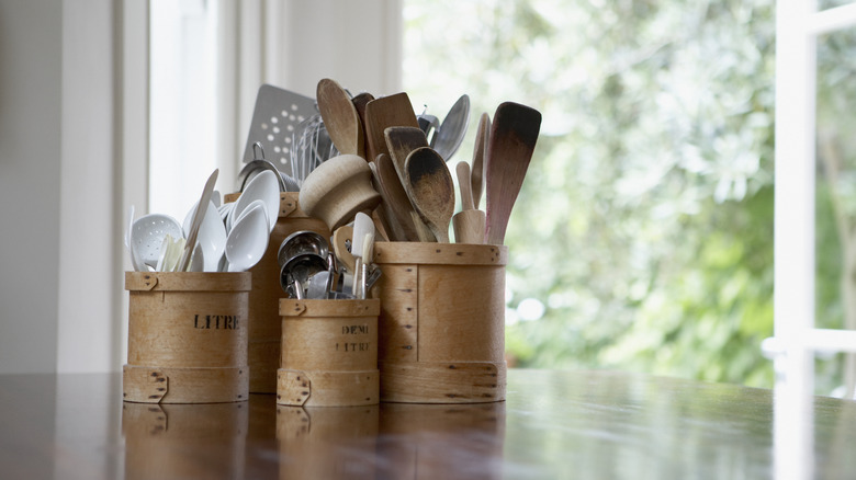 kitchen utensils in buckets on counter