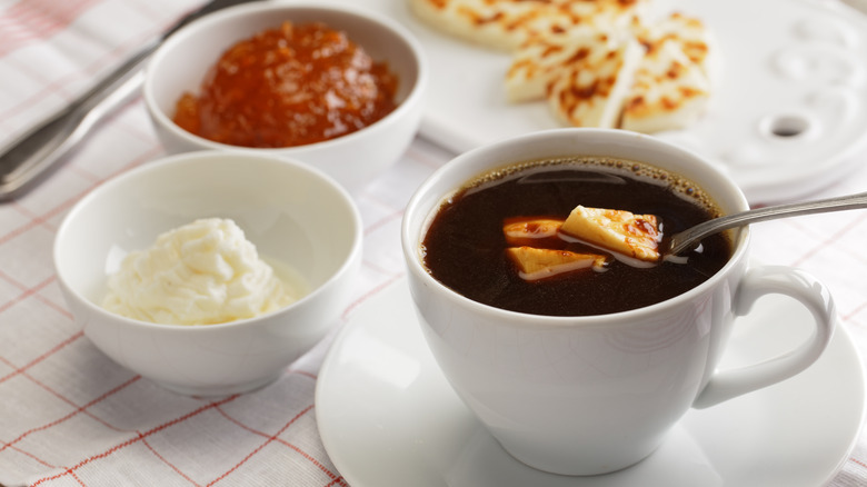 Kaffeost in mug with a breakfast spread