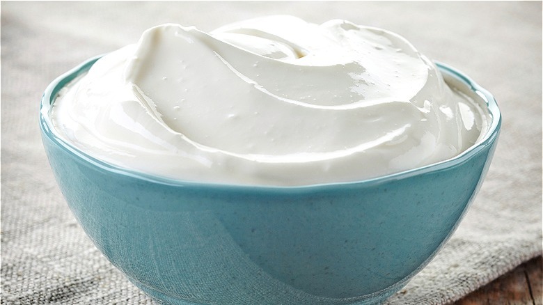 Blue bowl filled with sour cream 