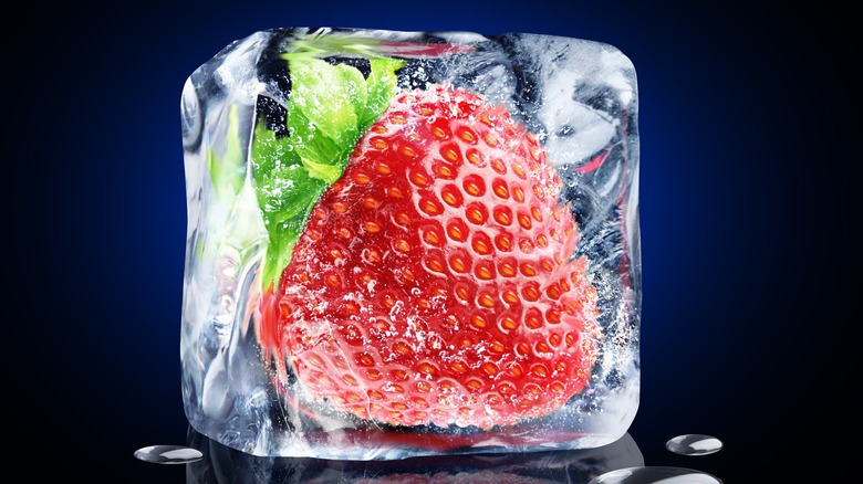 whole strawberry frozen in ice 