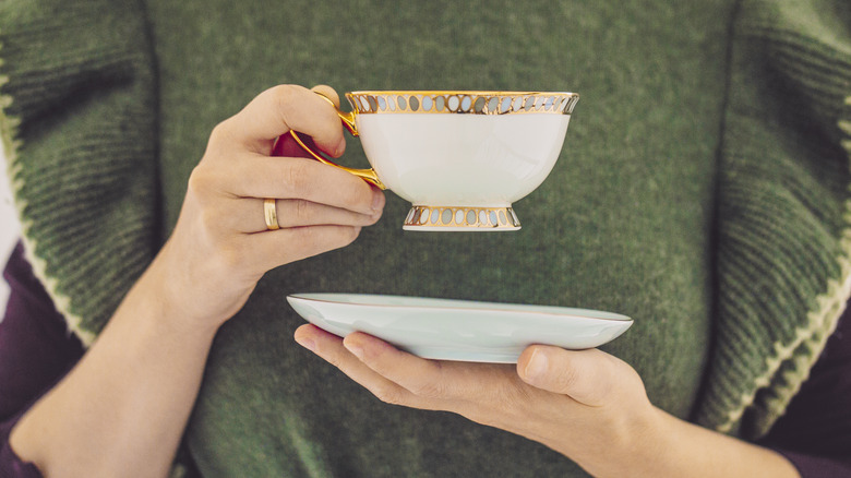 Person holding tea cup