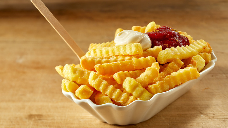 Fries with sour cream and ketchup