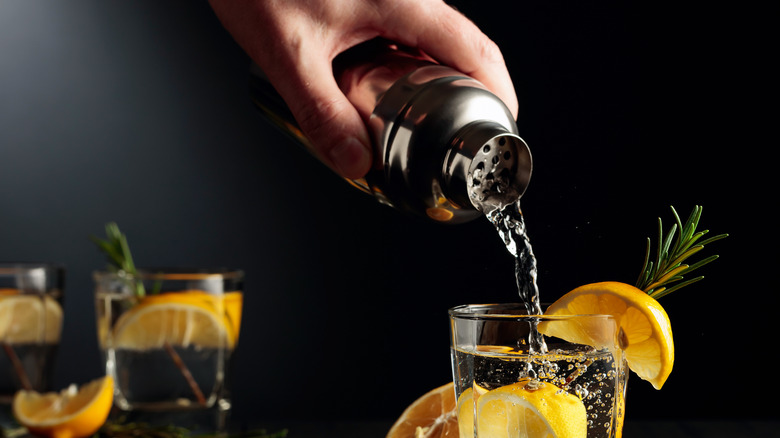 pouring a cocktail from shaker 