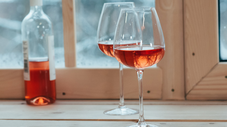 Rosé glasses with half-full bottle