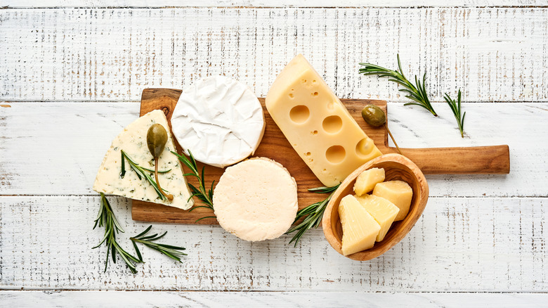 Cheeses on wooden board