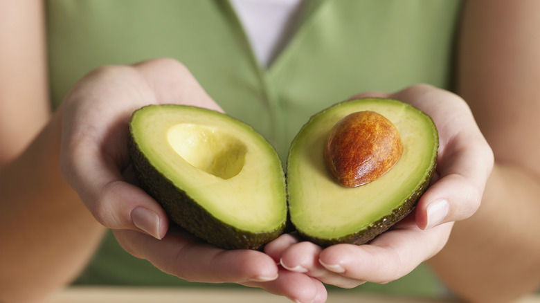 someone holding avocado