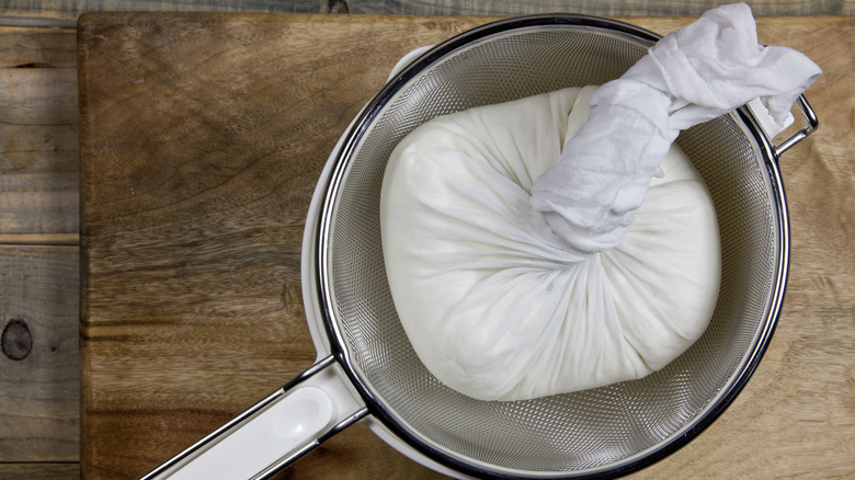 paneer block draining in strainer