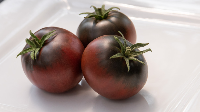 Cherokee purple tomatoes on white plate