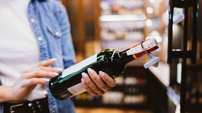 woman reading wine label